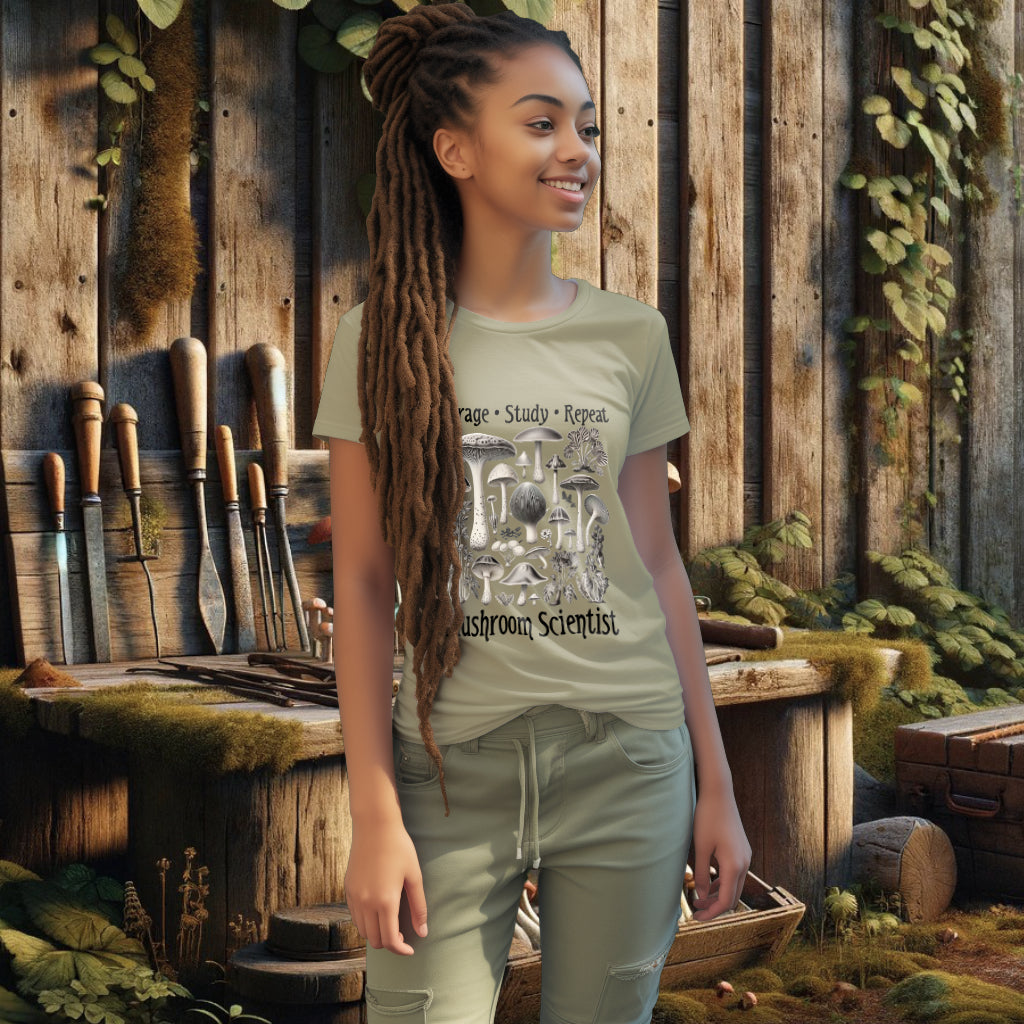 Model wearing the 'Forage, Study, Repeat' Tee Shirt in sage, showcasing an antique-style mushroom illustration, perfect for those who cherish the art of mycology and sustainable fashion.