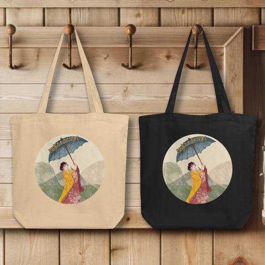 Collection of 'Magic is in the Heart' Totes in black and oyster colors, elegantly displayed on hooks, each tote illustrating the enchanting kimono-clad figure, embodying the spirit of wonder and elegance.