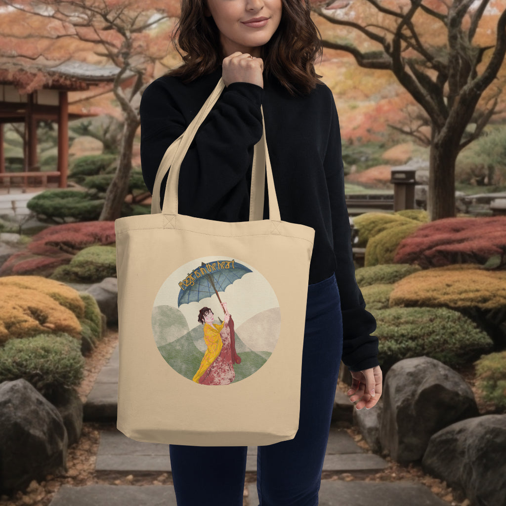 The 'Magic is in the Heart' Tote in oyster color carried by a model, highlighting the artistic and vibrant kimono scene, ideal for eco-conscious individuals who cherish artistry and cultural richness.
