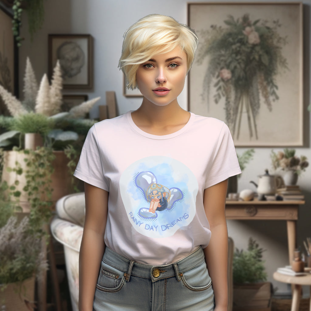 The 'Rainy Day Dreams' organic cotton tee in a soft Cotton Pink, modeled to highlight the bittersweet chibi design that encourages finding beauty in vulnerability and the solace of rainy moments.