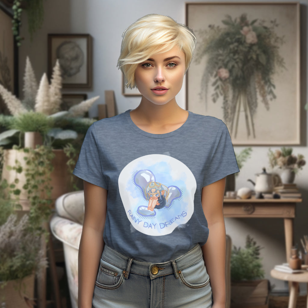 Displaying the 'Rainy Day Dreams' T-Shirt in Dark Heather Blue, the model highlights the design's blend of a melancholic chibi character and the inspiring reminder to find magic in the heart amidst the rain.