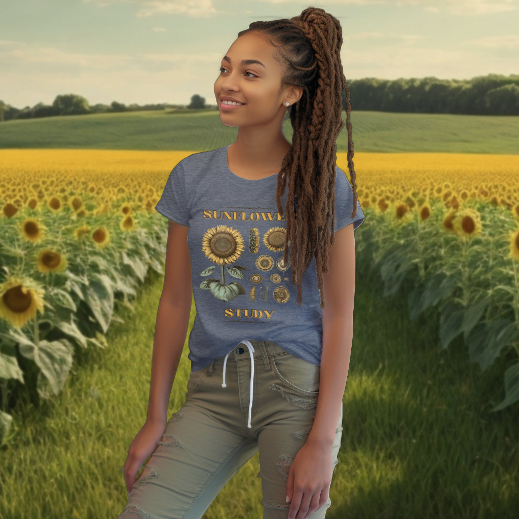 The 'Sunflower Study' Tee Shirt in dark heather blue on a model exemplifies a blend of fashion and natural science, with its precise sunflower illustration appealing to nature enthusiasts.