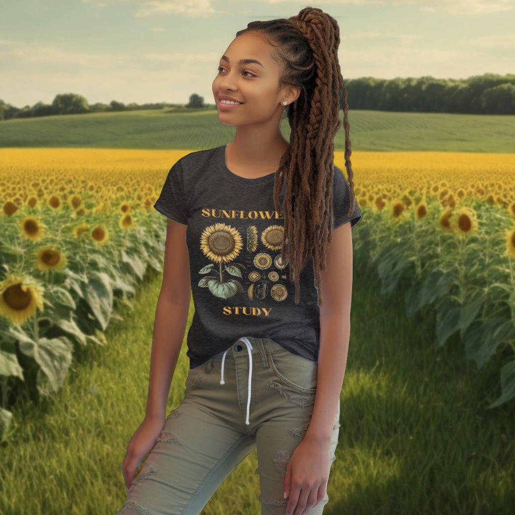 Displaying the 'Sunflower Study' dark heather grey Tee Shirt, the model showcases the intricate sunflower artwork, a wearable tribute to the beauty of nature for the eco-savvy individual.