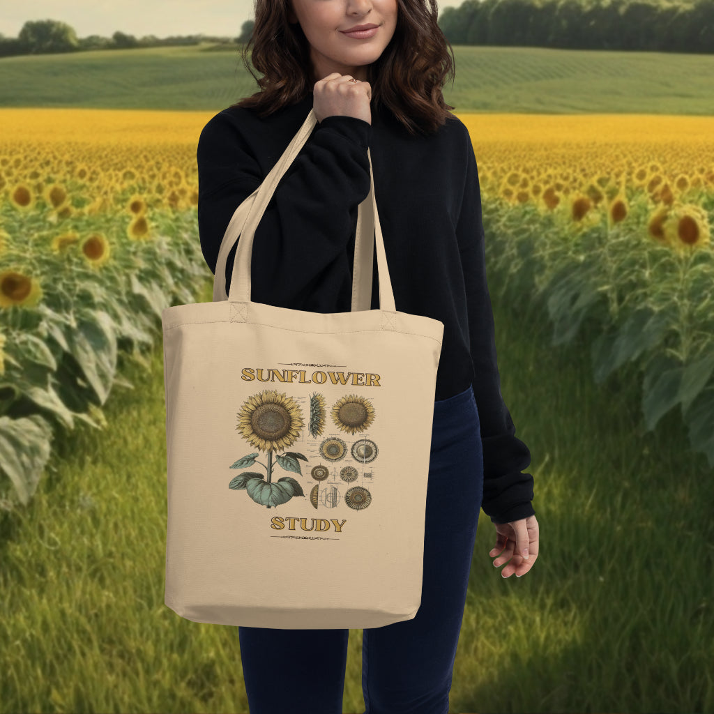 Model showcasing the 'Sunflower Study' Sunflower Tote Bag in oyster, with the detailed sunflower botanical design, a stylish accessory for those who appreciate the intricacies of flora.