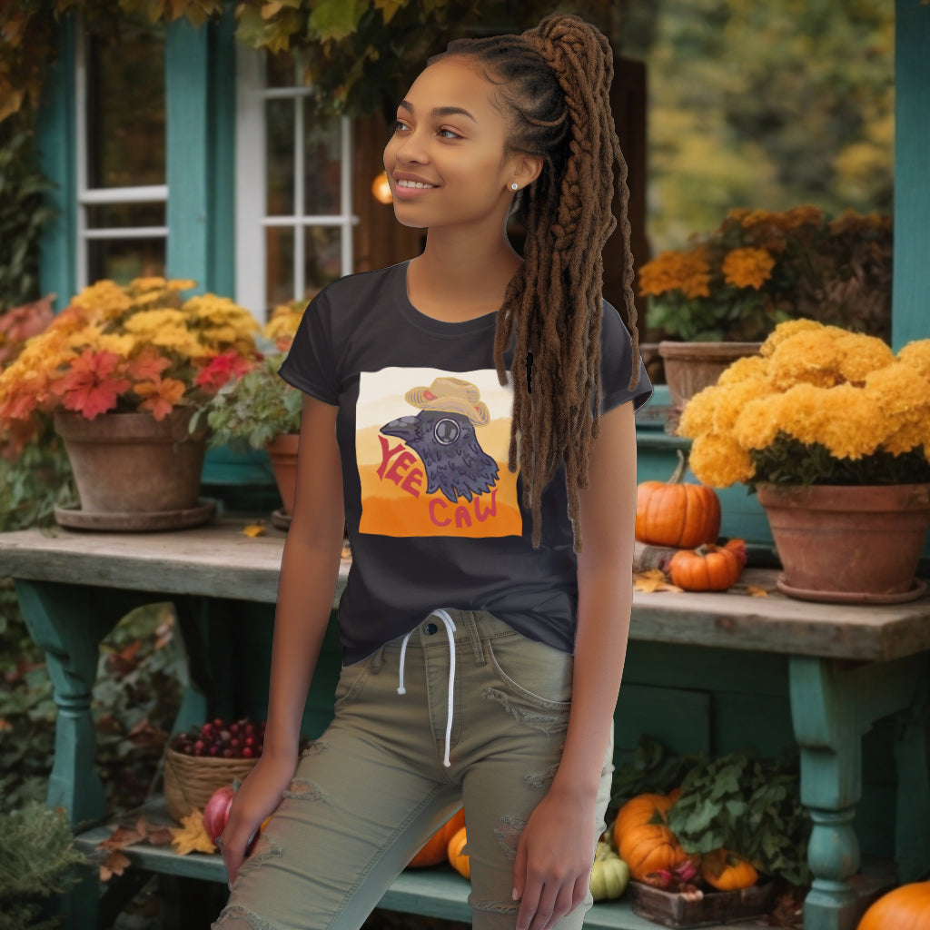 The 'Yee Caw' organic cotton Anthracite tee on a model features a whimsical crow head exclaiming "Yee Caw," bringing a lively artistry to the eco-conscious apparel.