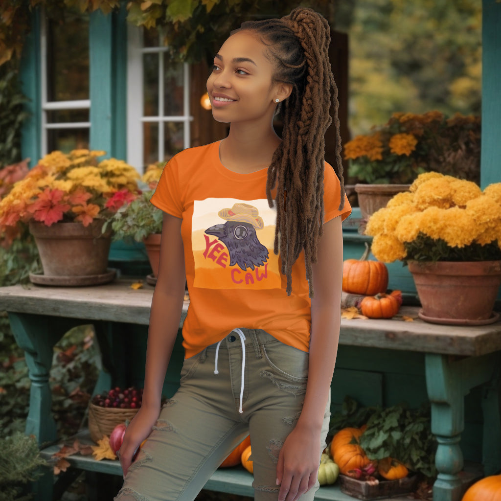 Wearing the 'Yee Caw' T-Shirt in Day Fall orange, the model radiates a playful spirit, with the vibrant design encouraging a lighthearted approach to life.