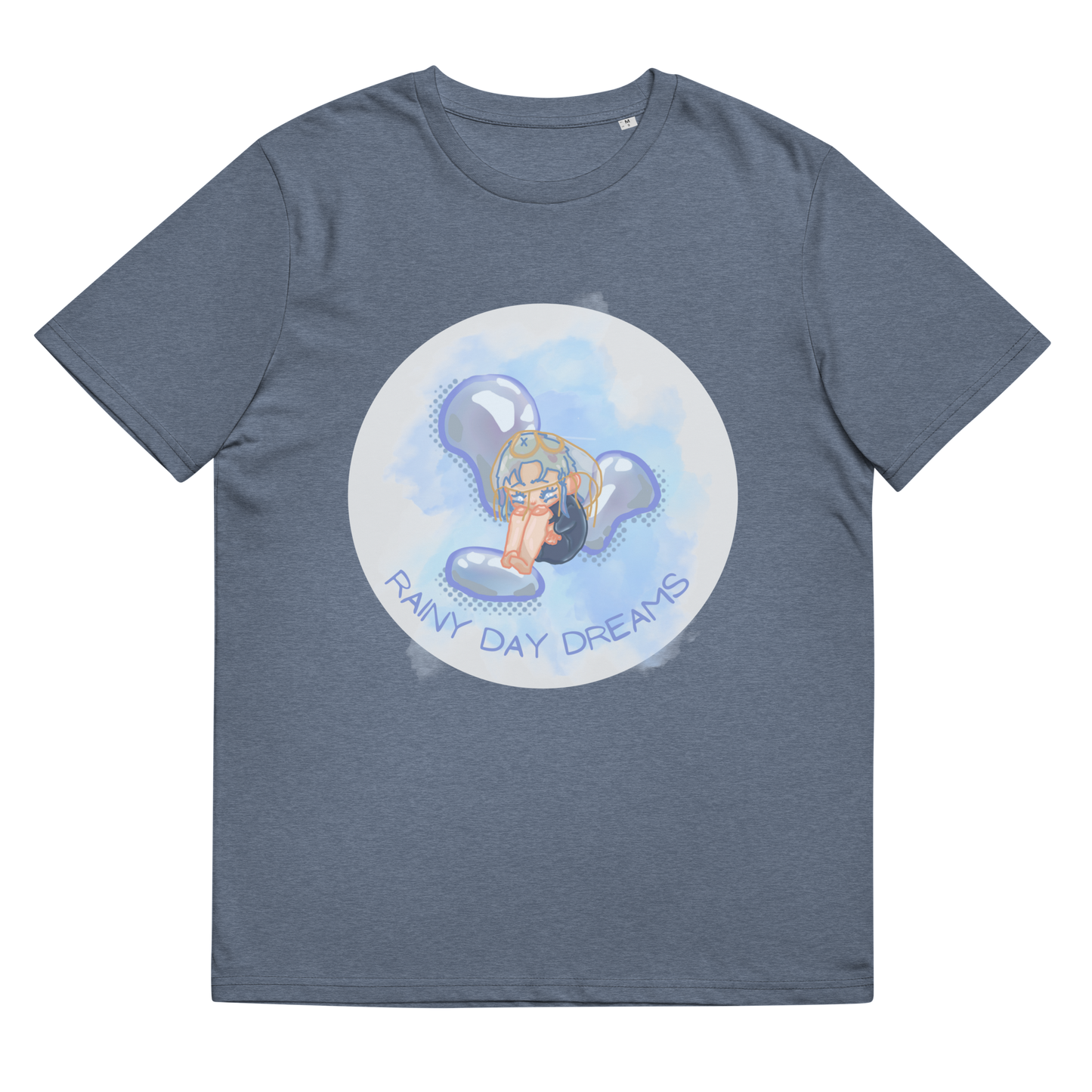 The 'Rainy Day Dreams' design on a Dark Heather Blue tee, presented in a lay-flat image, showcases the wistful chibi figure and evocative text, a reminder of the introspective beauty found in quieter moments.