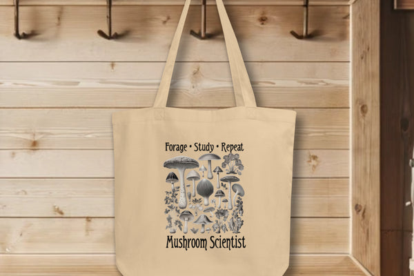 'Forage, Study, Repeat' Tote Bag in oyster color, displaying realistic, hyper-detailed mushroom renderings, capturing the essence of a scholar's dedication to fungi study.