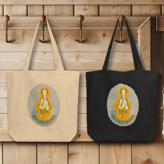 Collection of 'Goose-nana' Totes in black and oyster colors, elegantly displayed on hooks, each tote illustrating the charming and unique Goose-Nana design, embodying the spirit of playfulness and innovation.