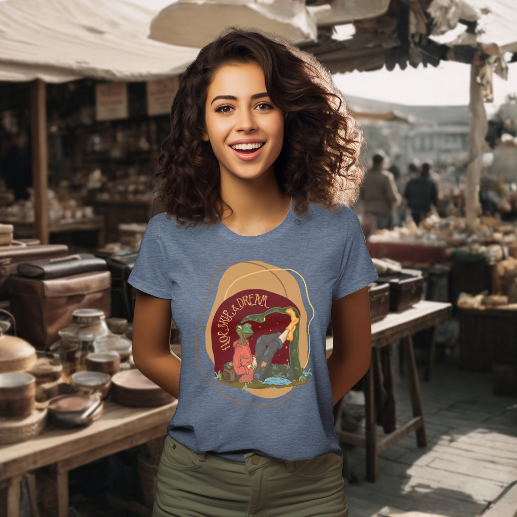 Model wearing the 'Hop, Skip, Dream' T-Shirt in Dark Heather Blue, highlighting the half frog, half human watercolor design, a whimsical portrayal of nature blended with human dreams.