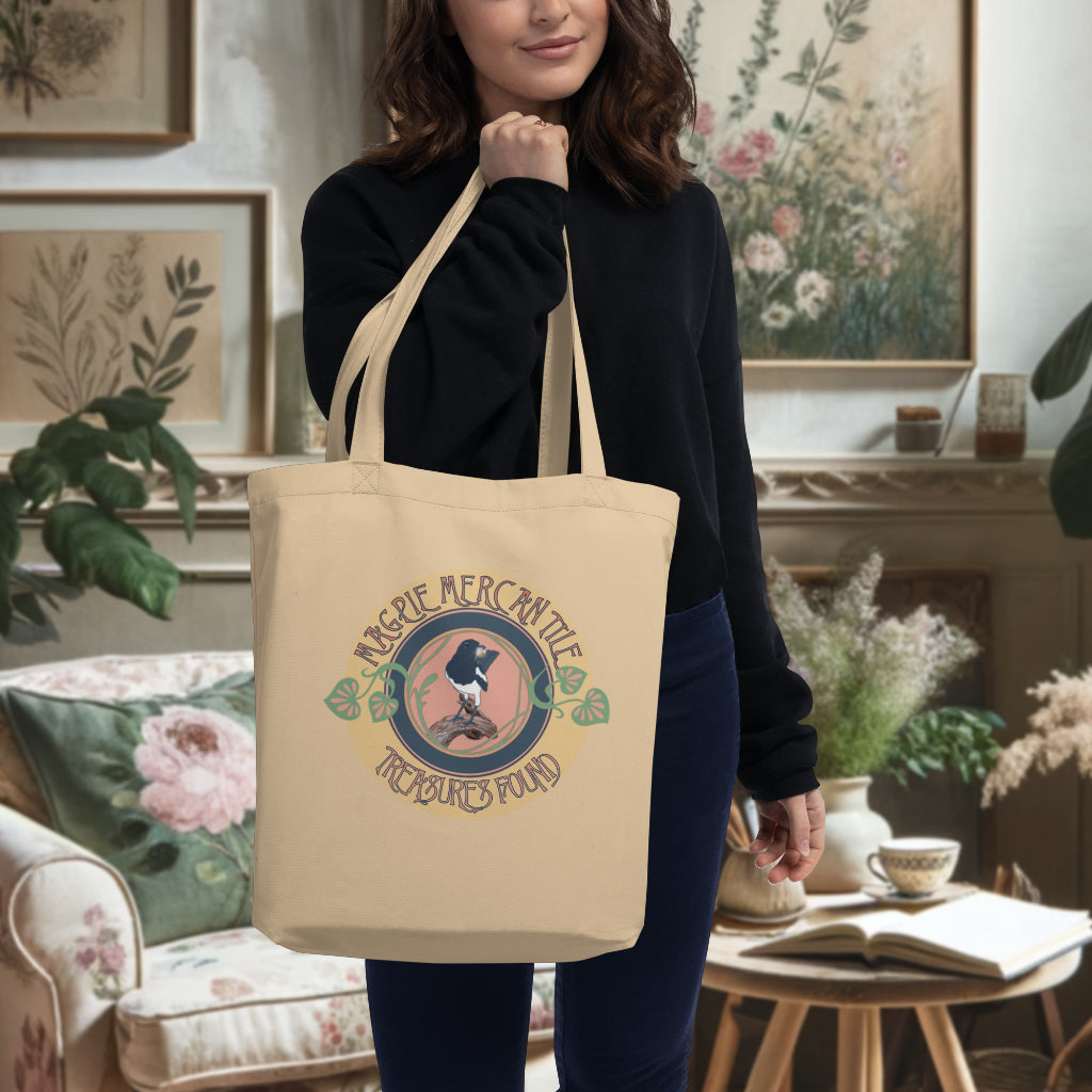 Model showcasing the 'Magpie Mercantile Logo' Tote in oyster, with the captivating watercolor magpie logo, a playful yet sophisticated accessory symbolizing the allure of unique treasures.