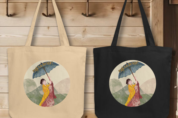 Collection of 'Magic is in the Heart' Totes in black and oyster colors, elegantly displayed on hooks, each tote illustrating the enchanting kimono-clad figure, embodying the spirit of wonder and elegance.