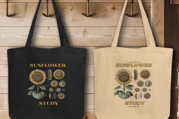 Group display of 'Sunflower Study' Sunflower Tote Bags in black and oyster, hanging on wall hooks, each bag featuring a detailed botanical illustration of a sunflower, showcasing the fusion of scientific art and sustainable fashion.