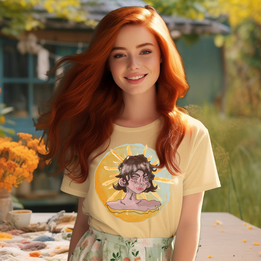 Model wearing the 'Sunshine Girl' T-Shirt in Butter, capturing the watercolor portrait of a thoughtful girl against a sun backdrop, blending Art Deco elegance with glitchy, modern art strokes.