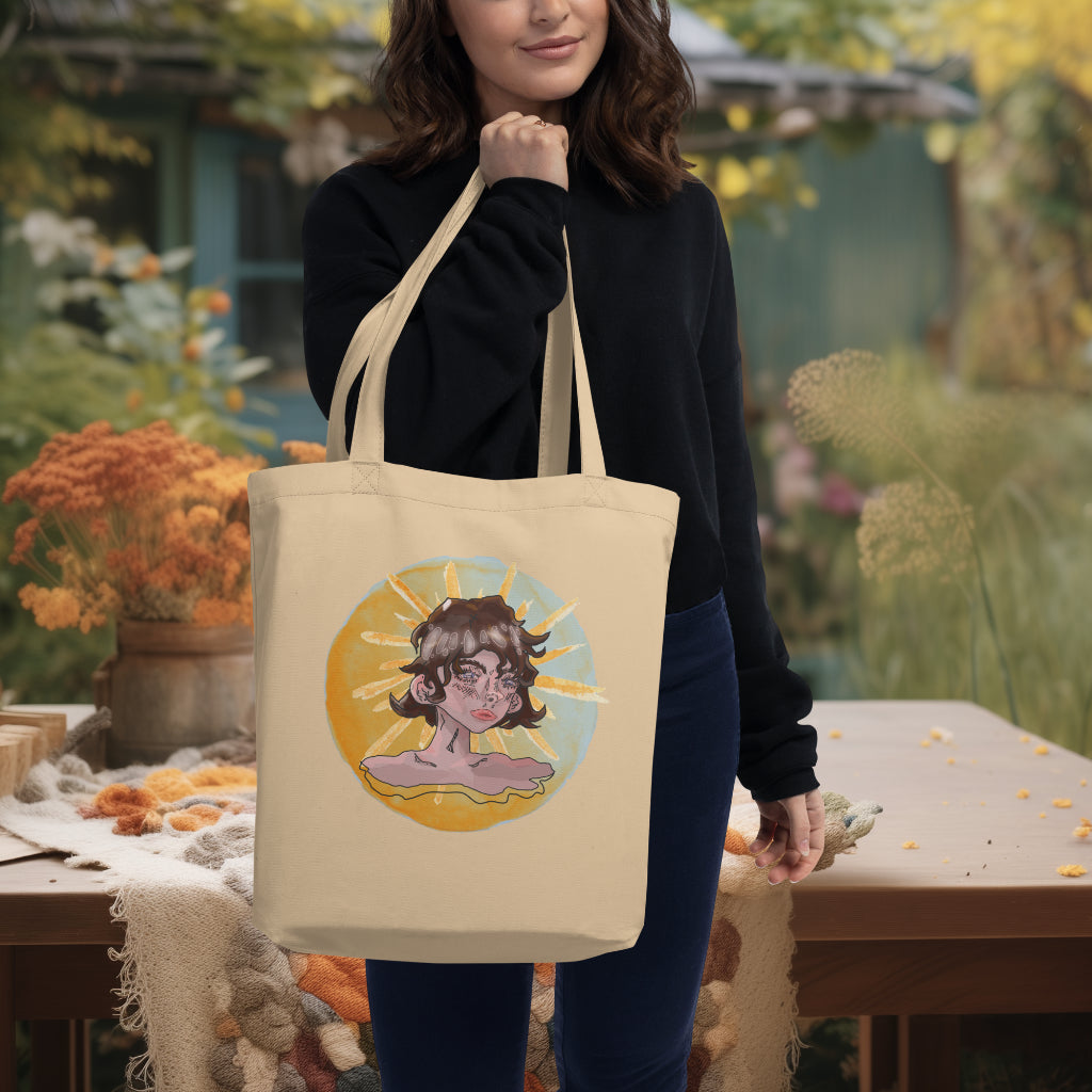 The 'Sunshine Girl' Tote in oyster color carried by a model, highlighting the artistic and evocative portrayal of the girl, ideal for eco-conscious individuals who cherish unique artistic expressions.