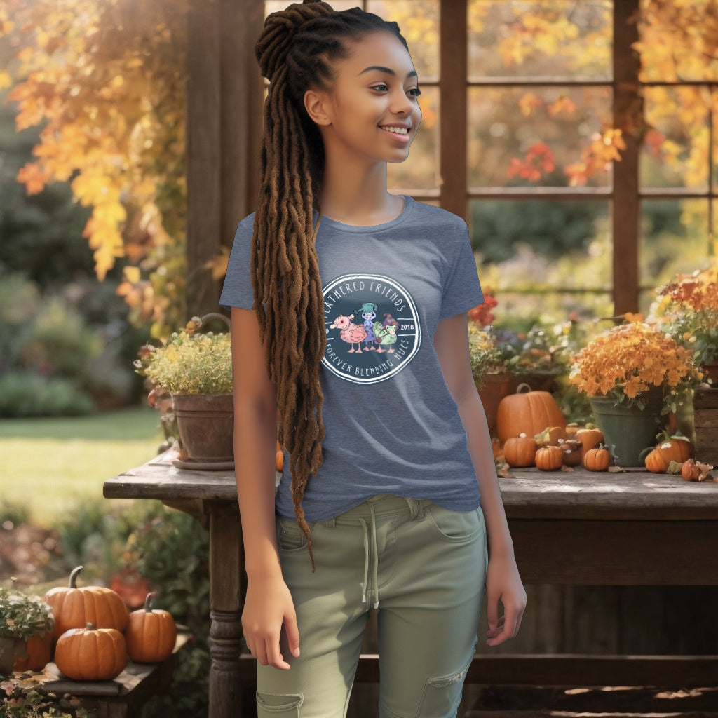 Model wearing the 'Feathered Friends' T-Shirt in Dark Heather Blue, adorned with a watercolor design of three ducklings with playful accessories, celebrating the joy of diverse friendships.