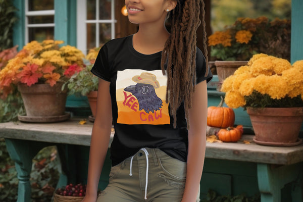 Model sports the 'Yee Caw' T-Shirt in Black, with a crow in a straw hat design, infusing playfulness and a rustic charm into the sustainable fashion choice.