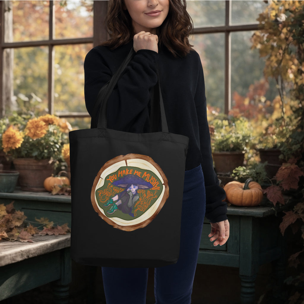 Model carrying the 'You Make Me Mushy' Tote in black, accentuating the delightful mushroom girl design, a perfect blend of functionality and a playful expression of nature's charm.