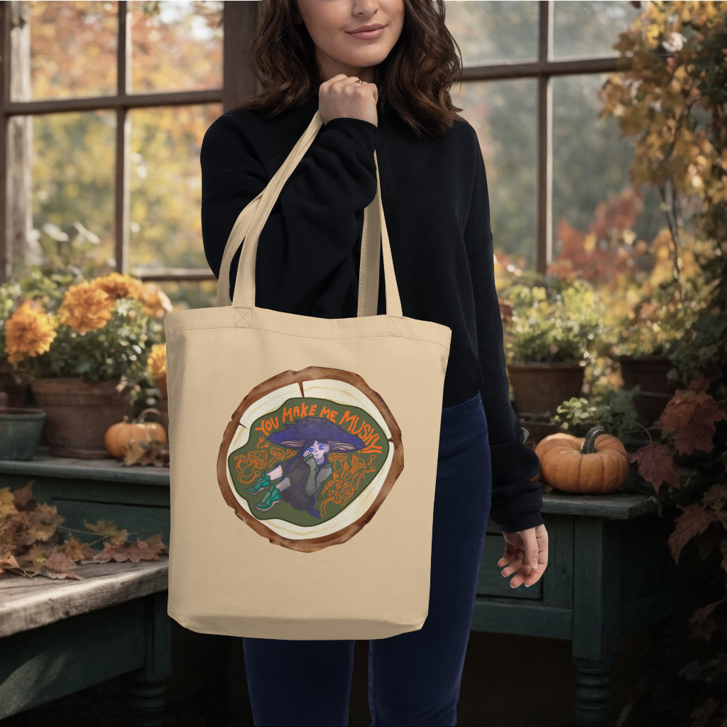 The 'You Make Me Mushy' Tote in oyster color carried by a model, highlighting the magical and vibrant mushroom design, ideal for eco-conscious individuals who love to express their joyful side.
