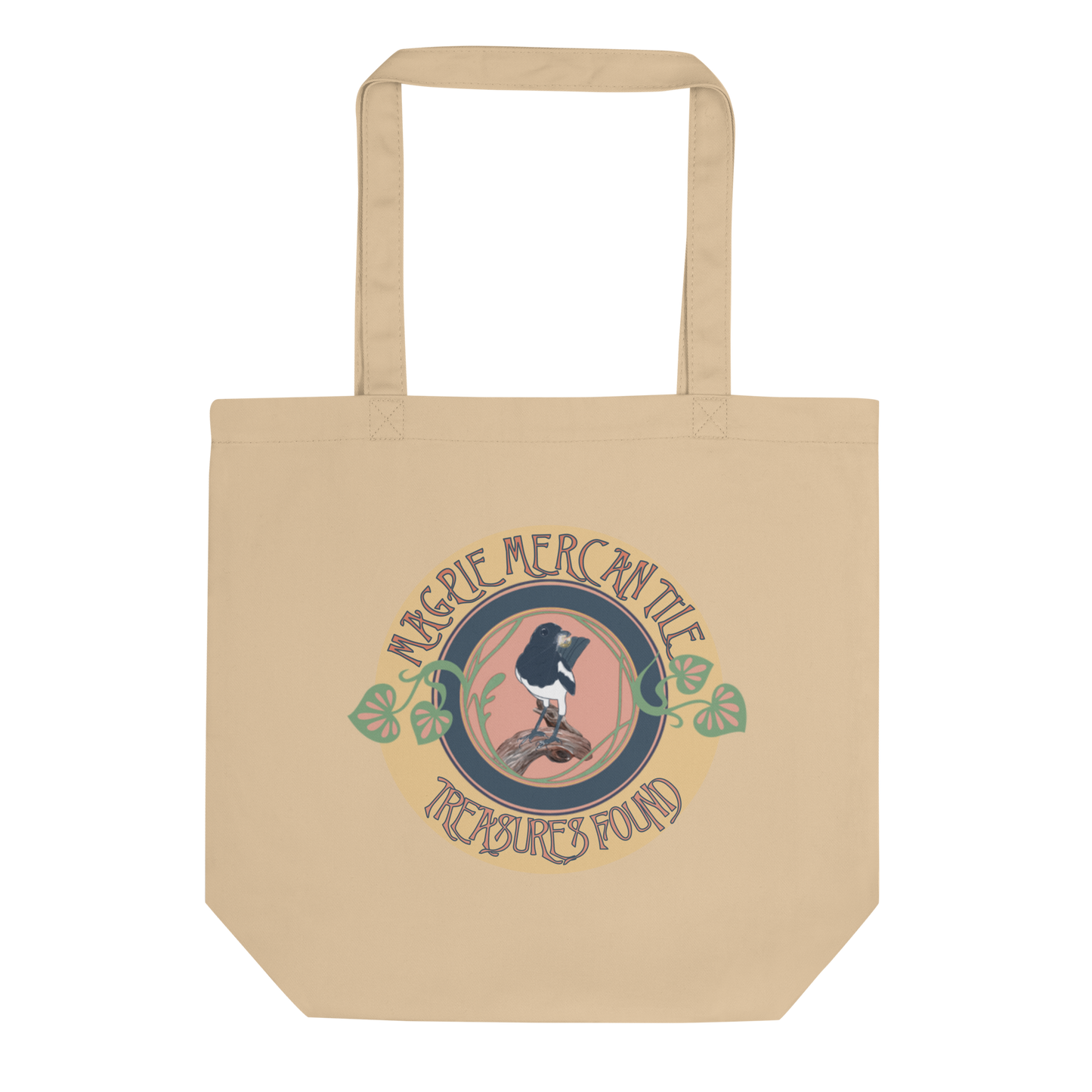 The 'Magpie Mercantile Logo' Tote in oyster color, presented in a lay-flat image, captures the charm of the magpie and botanic design, a stylish and sustainable option for the imaginative and environmentally aware.