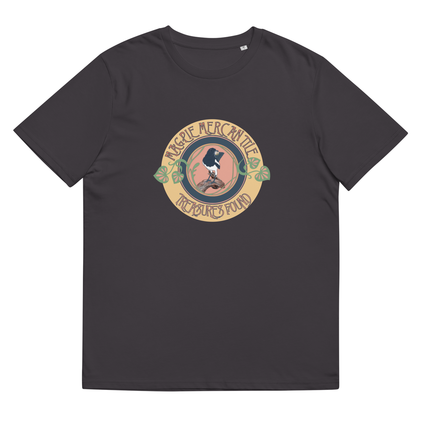 The 'Magpie Mercantile Logo' design on an Anthracite tee, presented in a lay-flat image, showcases the enchanting watercolor magpie and the Art Nouveau botanical motif, inspiring a sense of adventure and style.