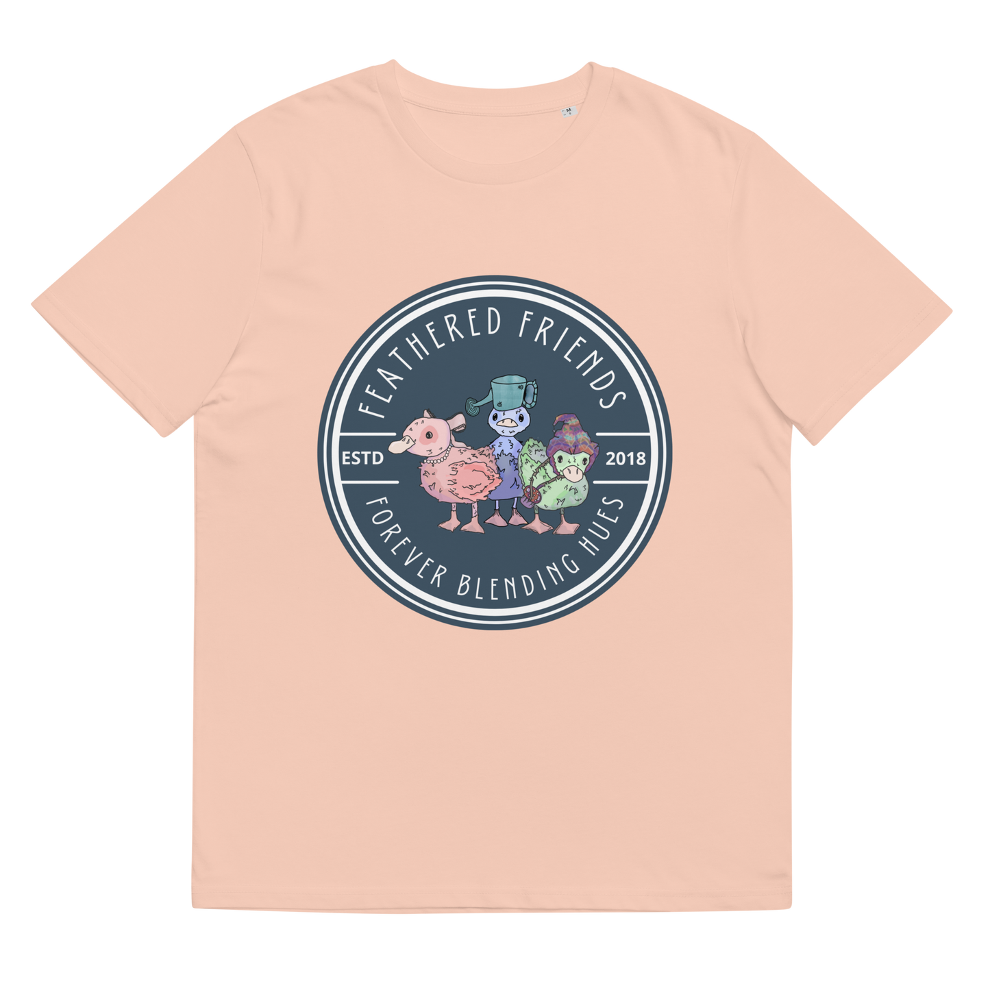 Lay-flat view of the 'Feathered Friends' T-Shirt in Fraiche Peche, showcasing the watercolor artwork of accessorized ducklings, an artistic tribute to the beauty of varied friendships.